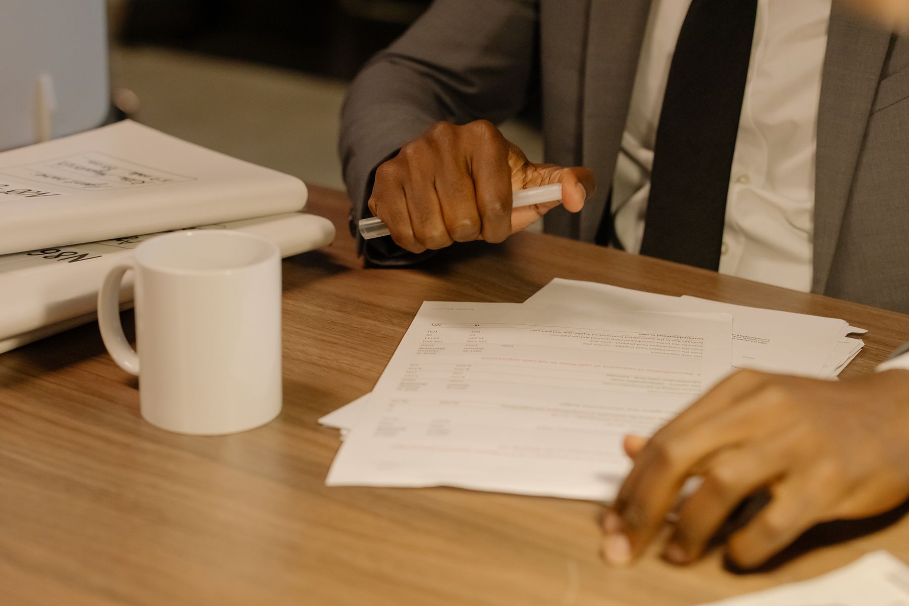 Printed financial statements and a cup of coffee on a desk