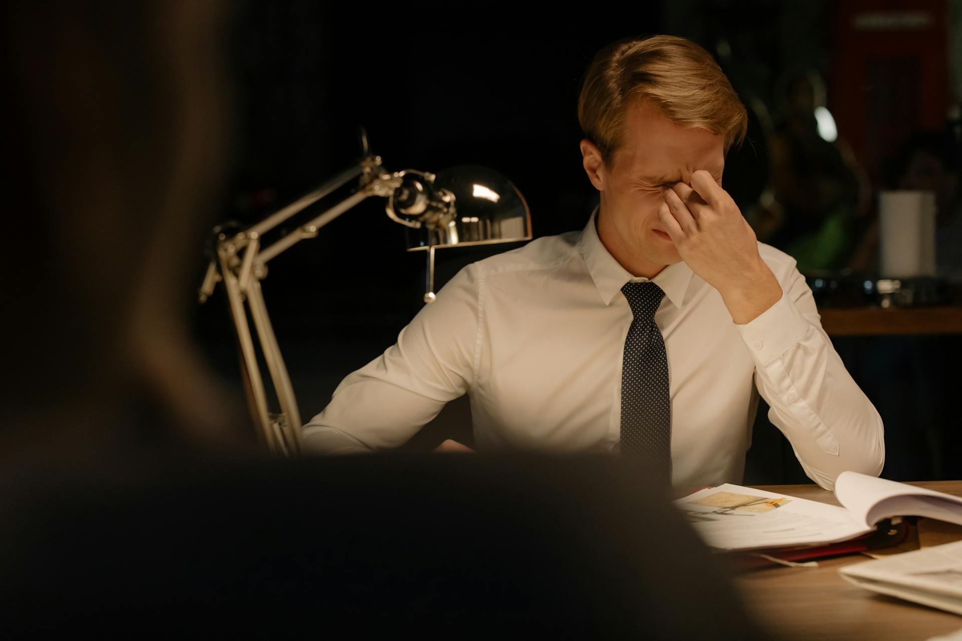 Man in White Long Sleeves Working inside the Office