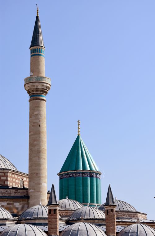 Free A stunning view of the Mevlana Museum and its vibrant minarets under a clear blue sky. Stock Photo