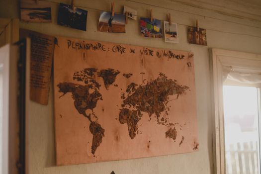 A handcrafted wooden world map on a rustic wall adds a touch of vintage charm to any interior.