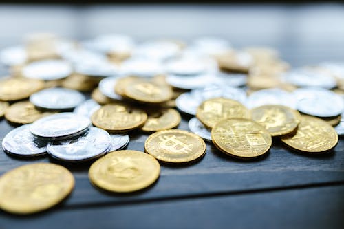 Free Close-Up Shot of Bitcoins on Wooden Surface Stock Photo