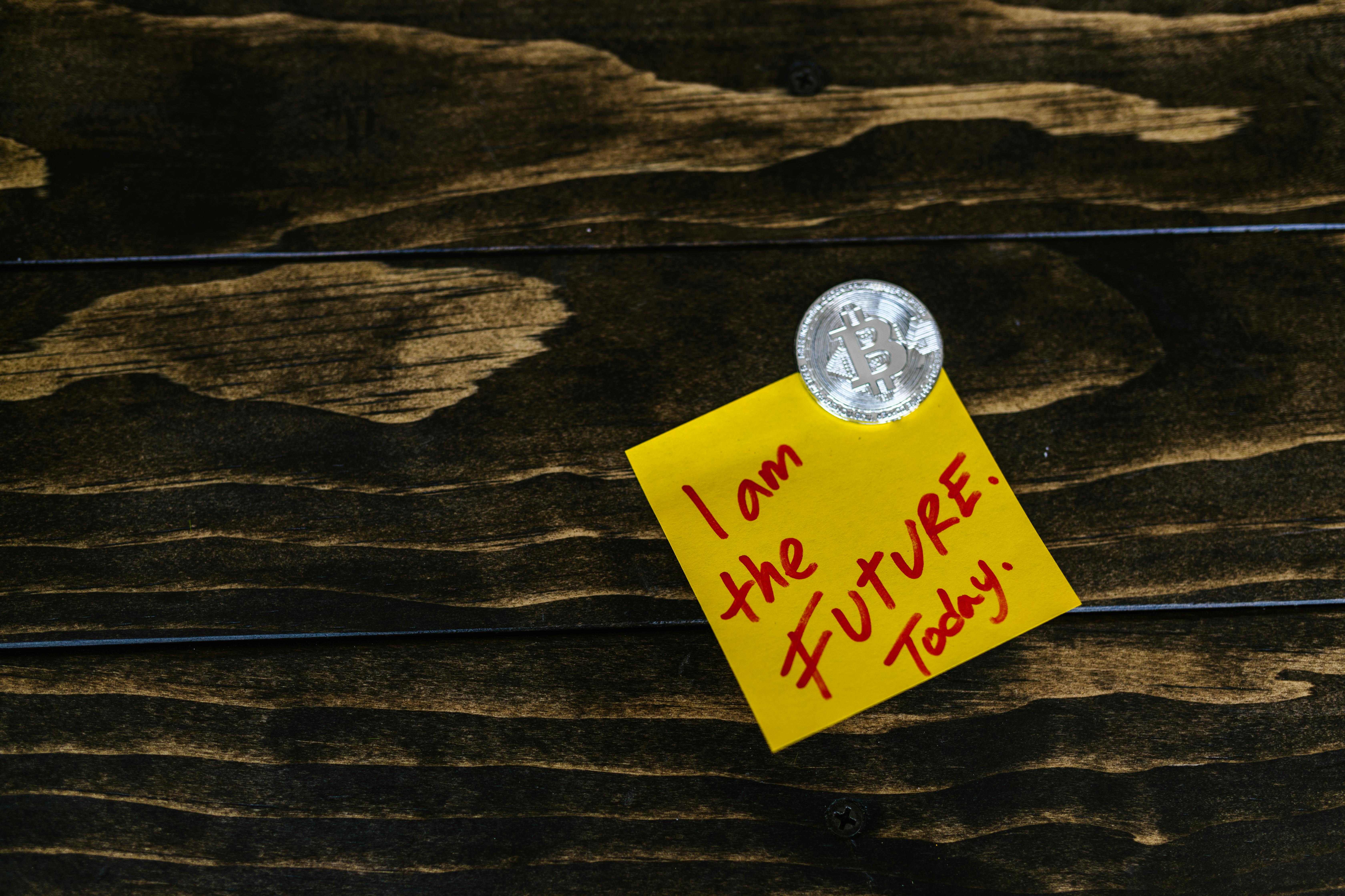 silver round coin beside yellow paper