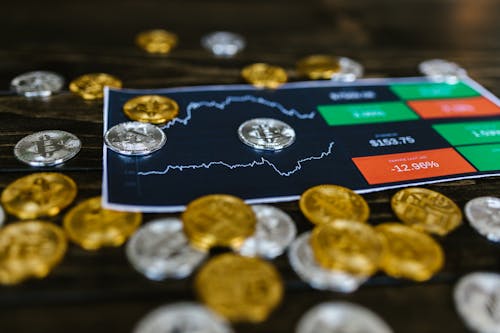 Selective Focus Photo of Silver and Gold Bitcoins