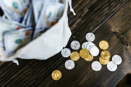Free Close-Up Shot of Silver and Gold Bitcoins on Wooden Surface Stock Photo