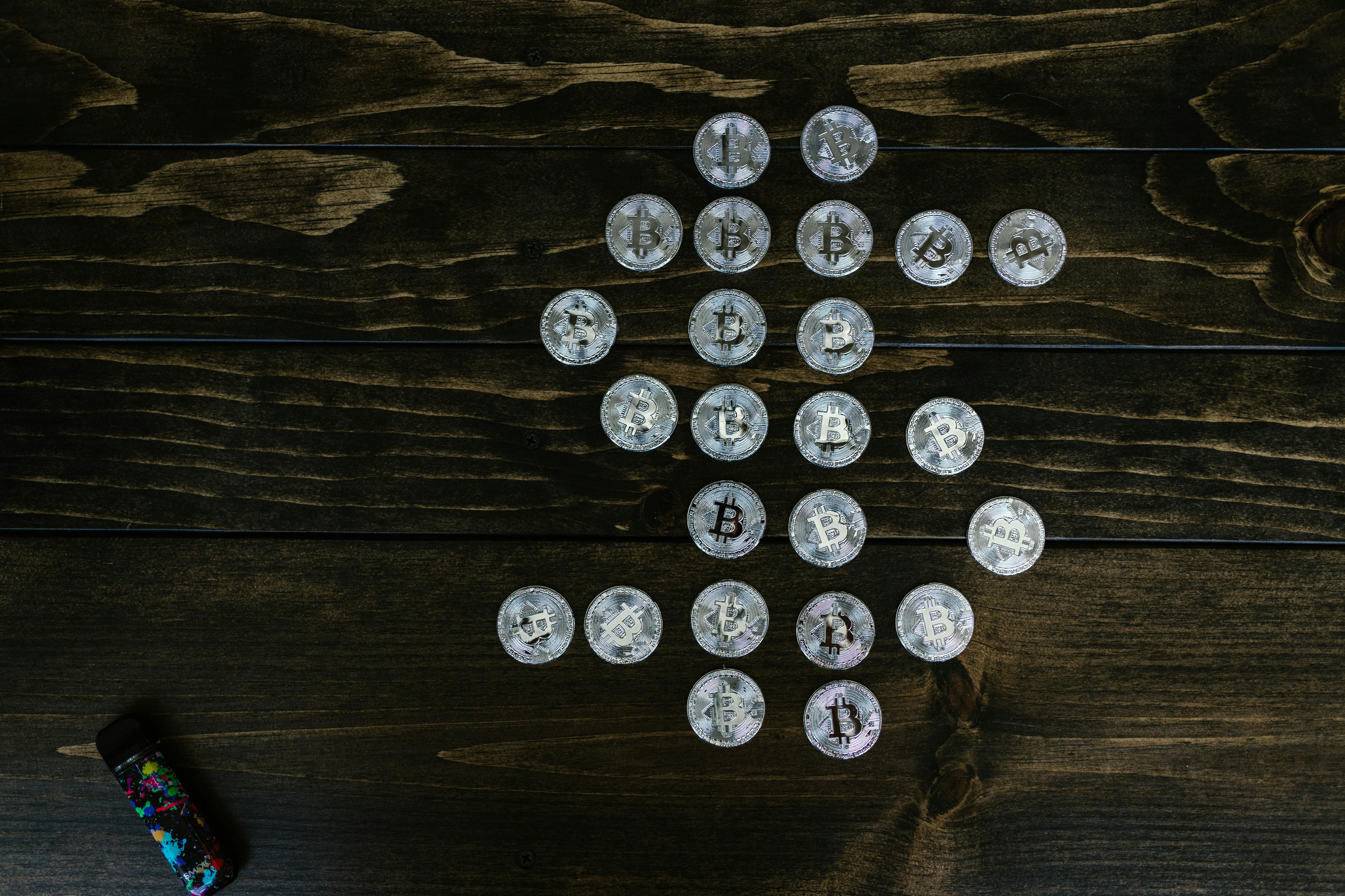 flat lay photography of bitcoins on wooden surface