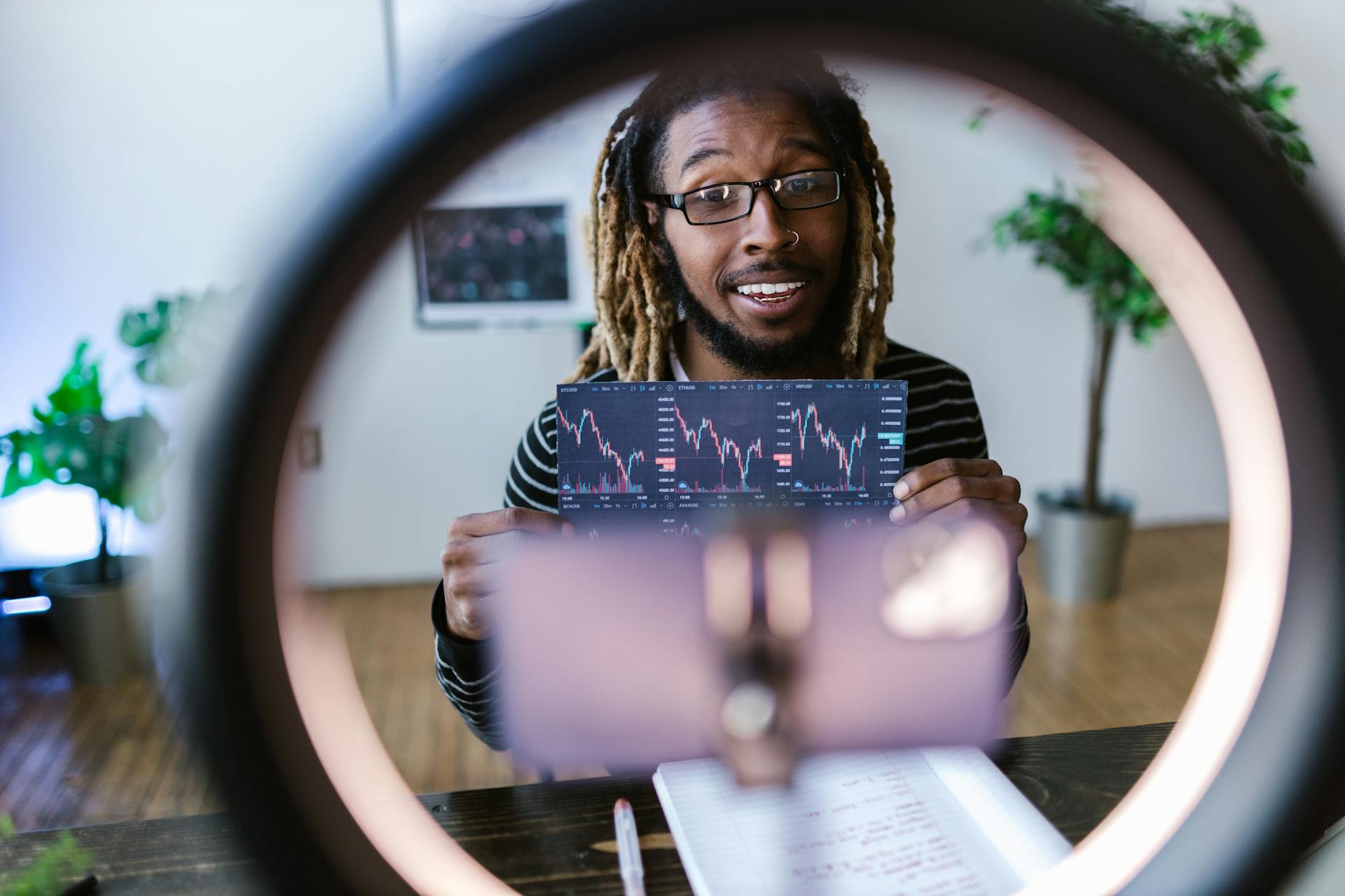 Selective Focus Photo of Man Holding Printed Chart of Stocks