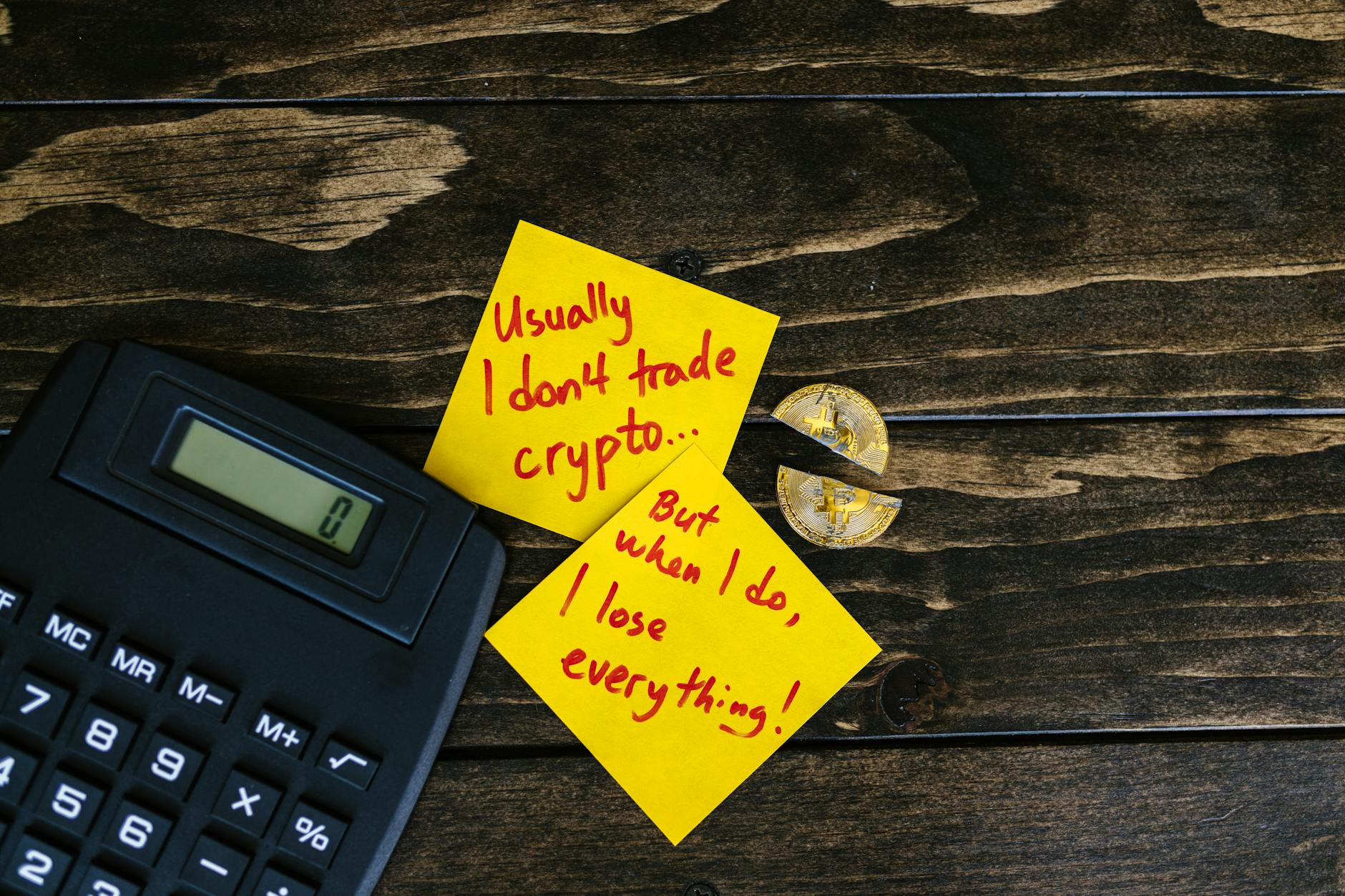 Broken Bitcoin and a Calculator Next to Sticky Notes with Sad Truth