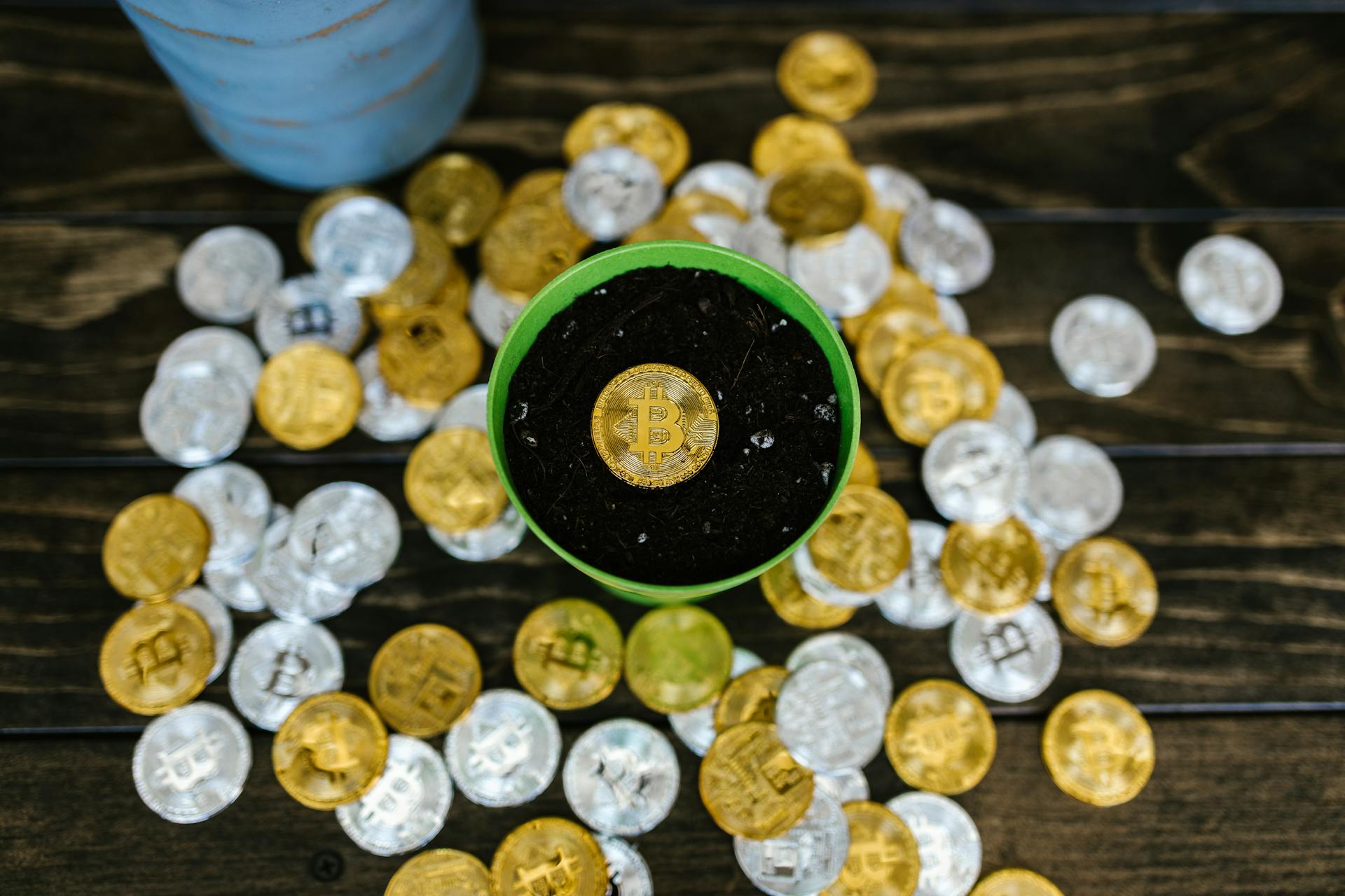 Cryptocurrency Coins on Table and in Pot