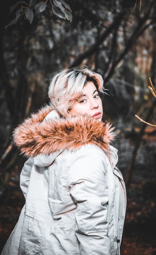 A Woman Looking Over Shoulder while Wearing a Fur Coat