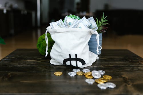 Free Money on a Tote Bags and Coins on the Table Stock Photo