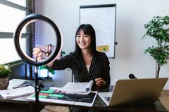 Creator presenting to camera behind a ring light — photo by RDNE Stock project on Pexels