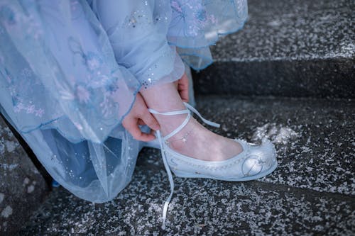 A Woman Tying Her Shoelace