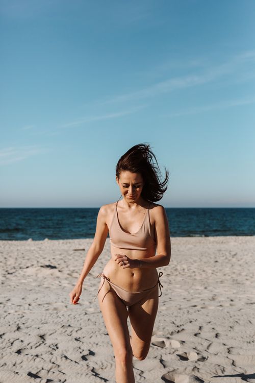 Woman in a Bikini Standing on Beach · Free Stock Photo