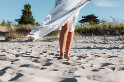 Free A Woman Standing on the Sand Stock Photo
