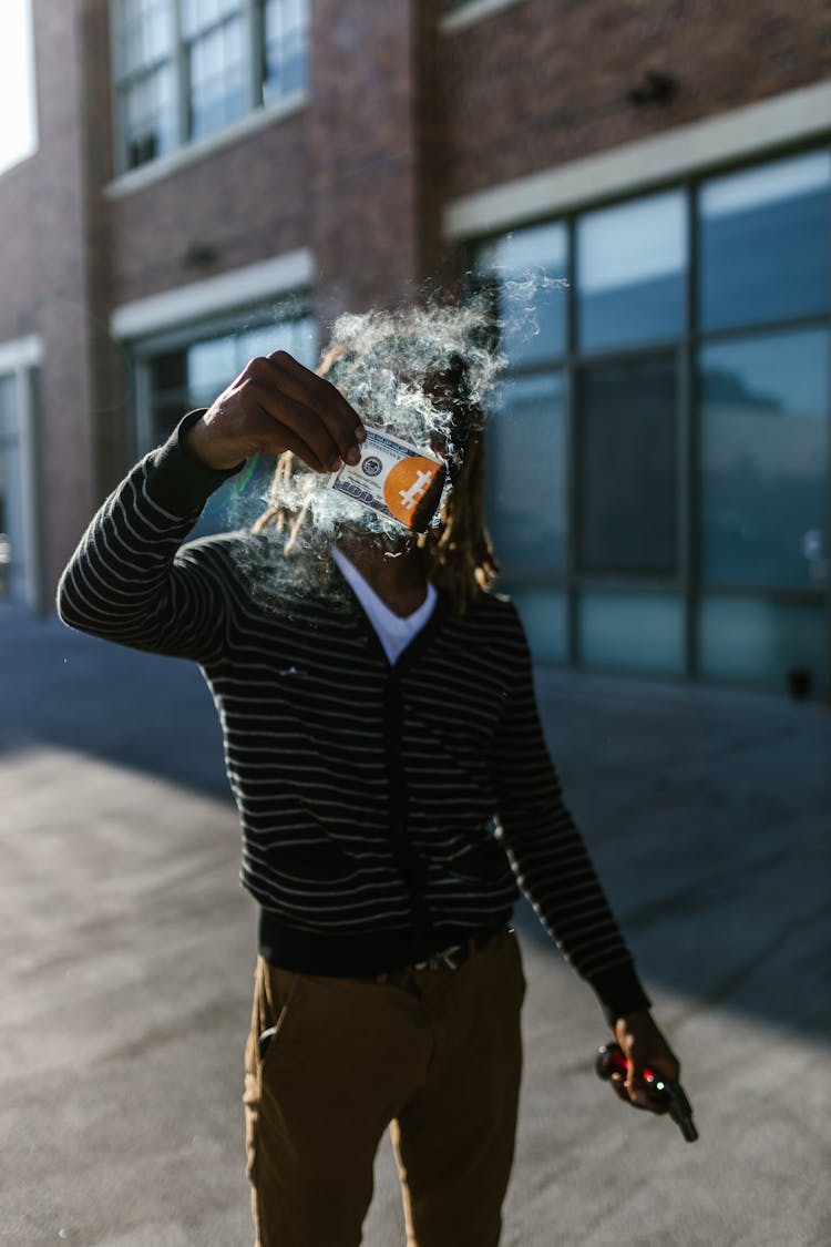 Man Holding A Dollar With Smoke 