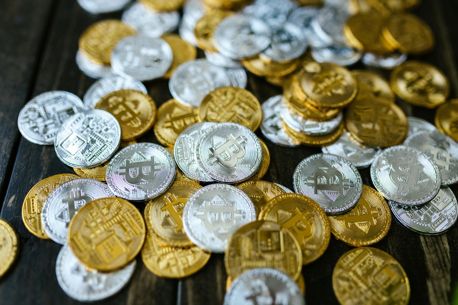 Close Up Shot of a Gold and Silver Bitcoins on Table