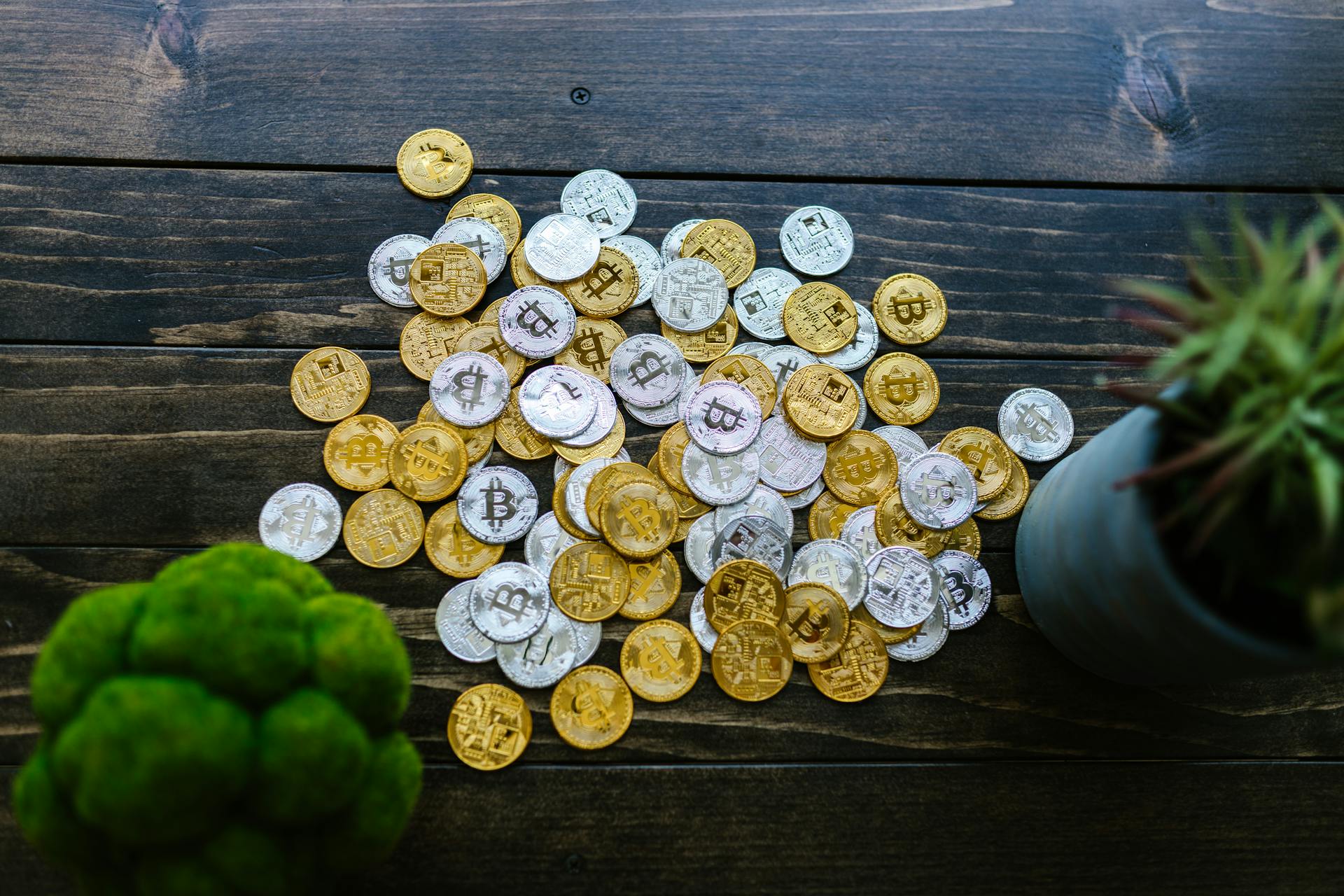 Silver and Gold Round Coins on Wooden Surface