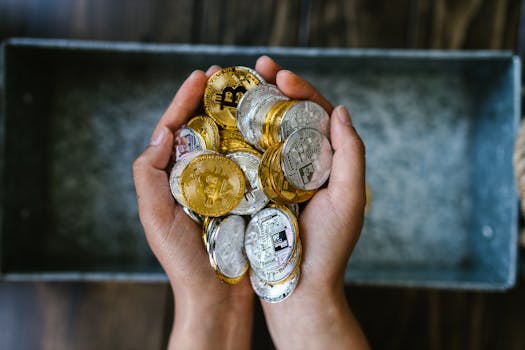 Close-up of hands holding gold and silver cryptocurrency coins, symbolizing digital investment.