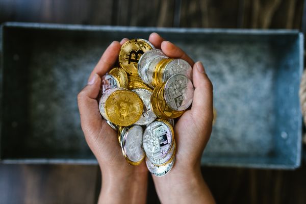 kenson Investments | Why Compute Power Is Becoming the New Oil in Blockchain Markets A man’s hand full of cryptocurrency
