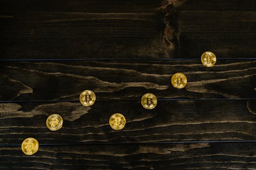 Golden Bitcoins on Wooden Planks