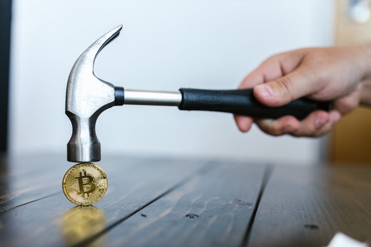 Person Hammering The Bitcoin