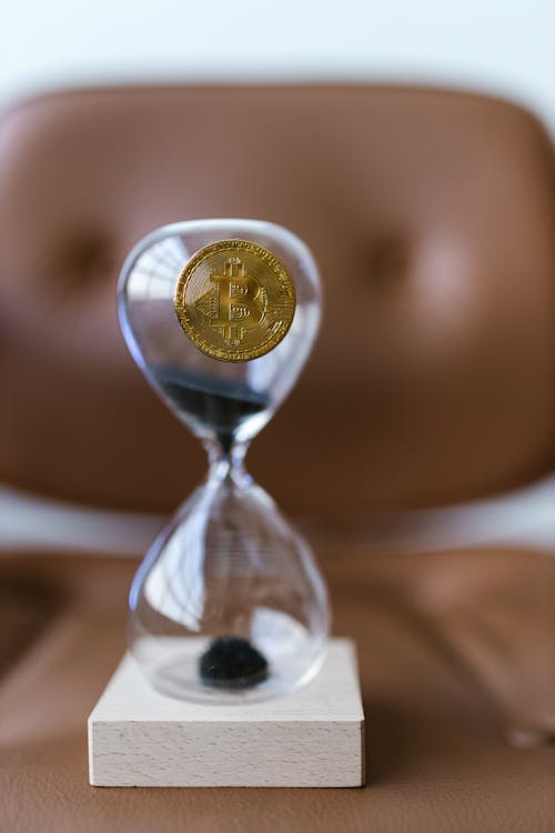 Free Gold Coin on a Hourglass Stock Photo