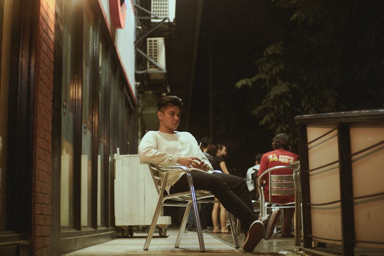 Man Sitting At Restaurant Patio With Soda