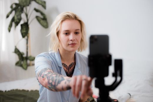Creator setting up a phone on a tripod by Ron Lach on Pexels