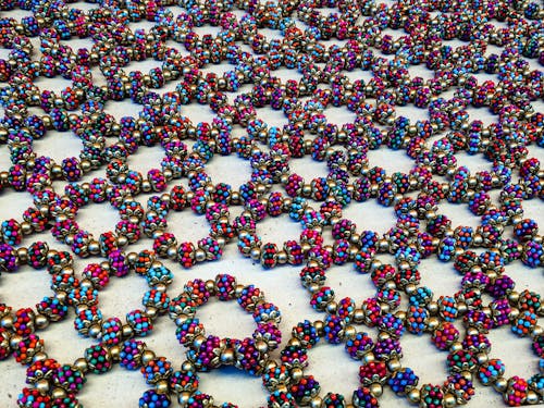 Muticolored Bead Bracelets Lying on a Table in a Geometric Pattern