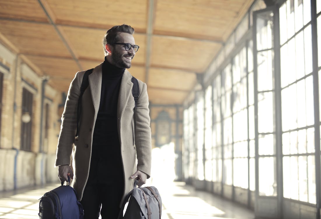 Free Man in Brown Robe Carrying Bag Smiling Stock Photo