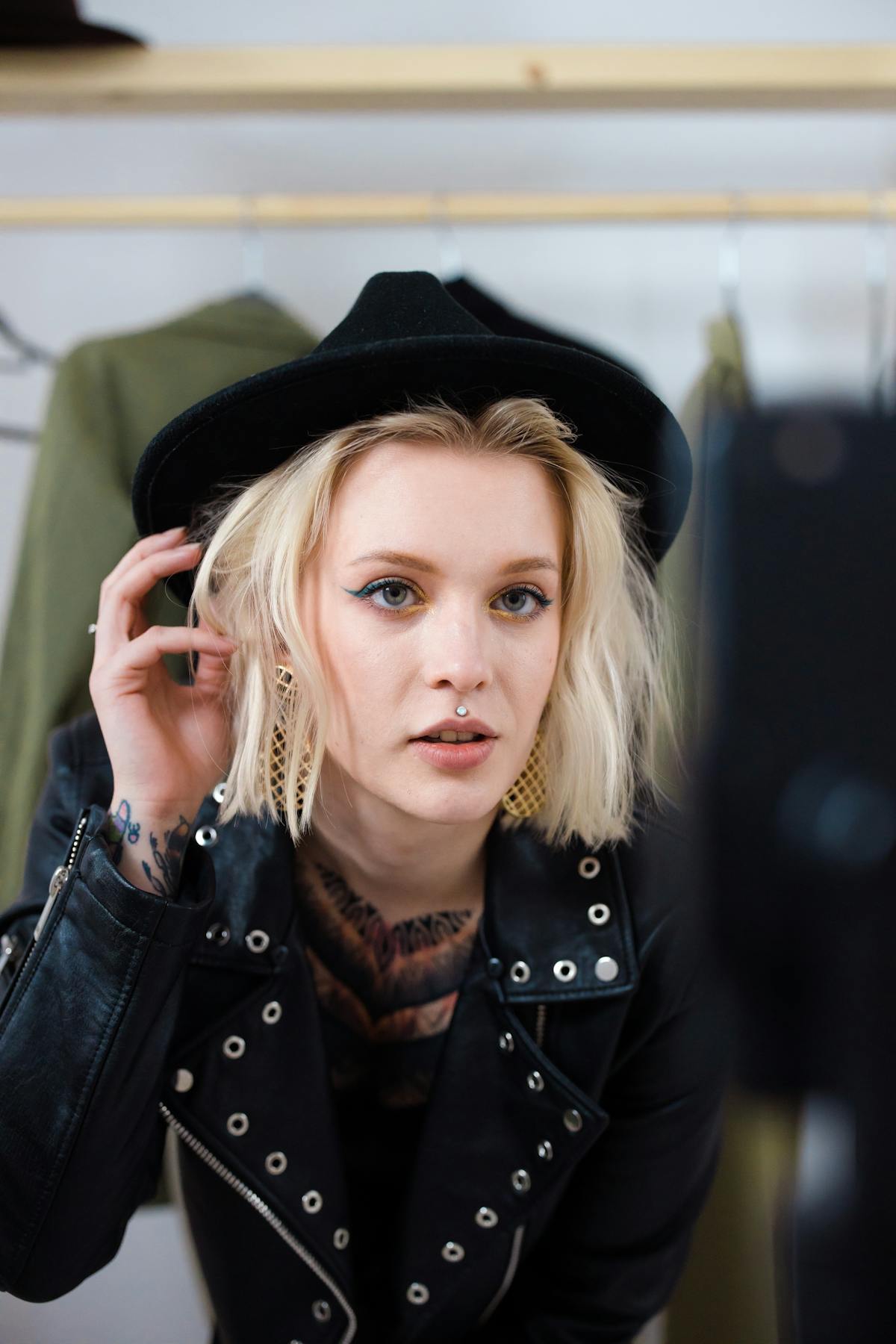 Woman using augmented reality mirror for virtual clothing try-on in a modern retail store