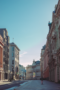 A quiet street in a historic European city with classic architecture and townhouses.