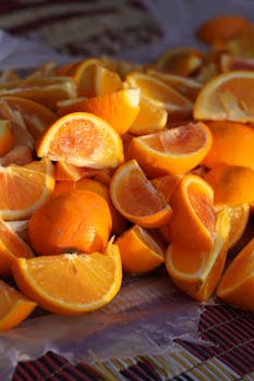A pile of fresh, juicy sliced oranges, perfect for a refreshing drink.