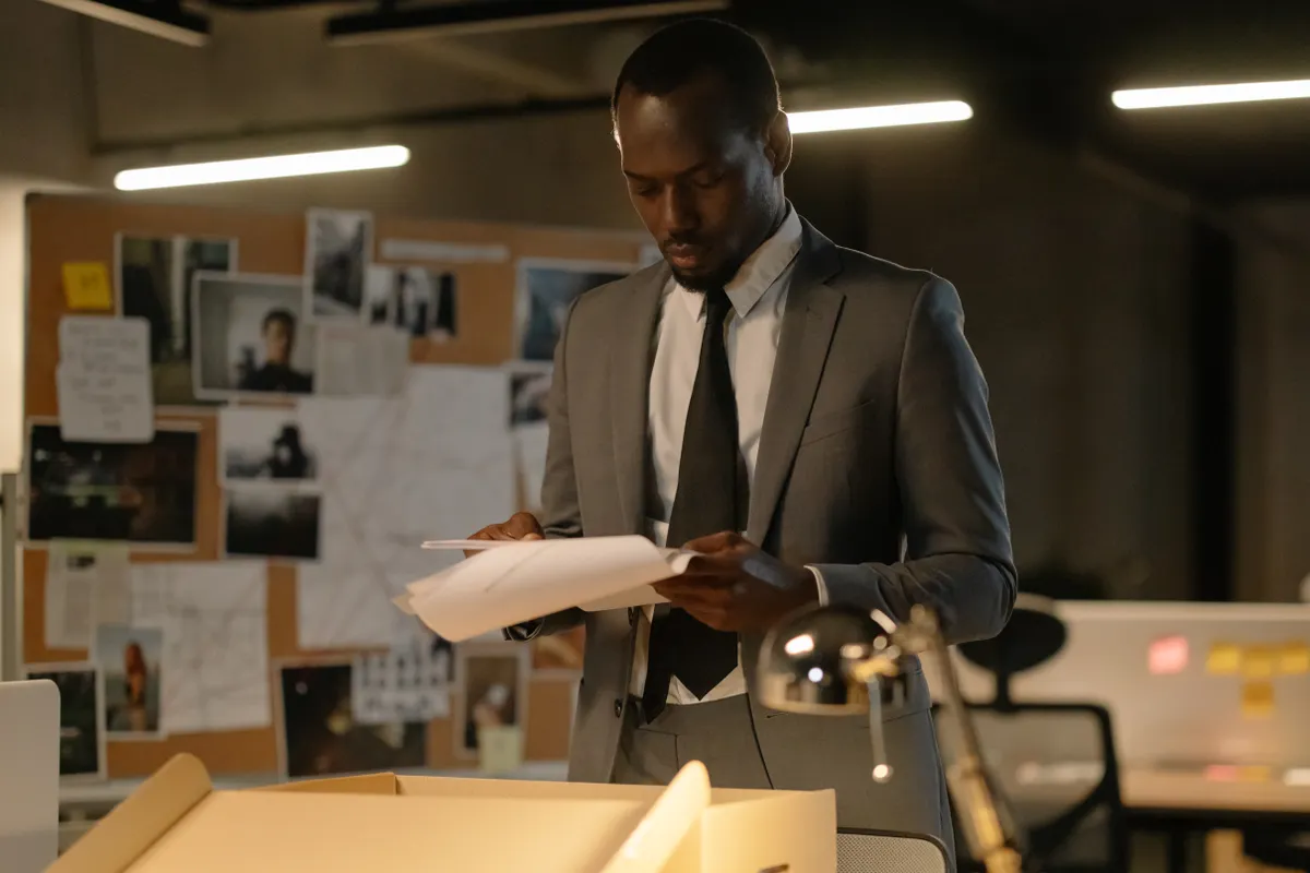 Focused lawyer in a suit reviewing documents, depicting the type of preparation a Supreme Court Advocate might undertake for legal representation.