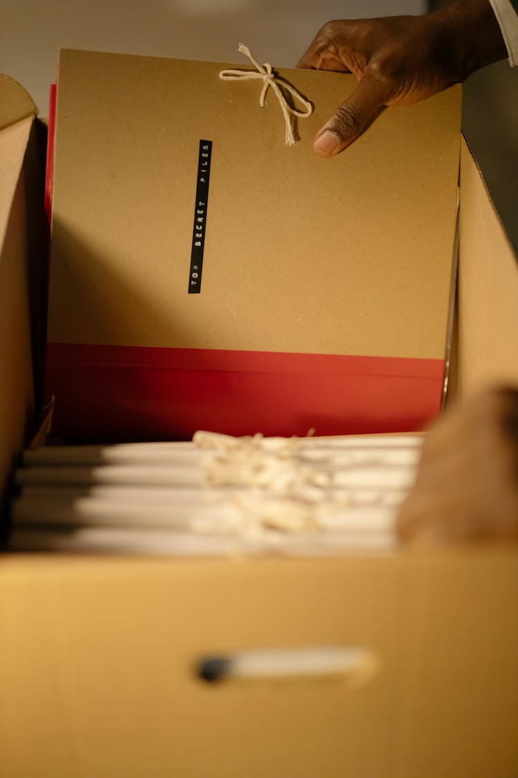 Close-Up Shot Of A Person Holding Files
