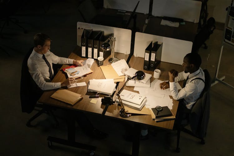 High Angle Shot Of Men Working In Front Of A Table 