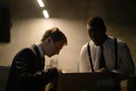 Men Looking Inside the Brown Box