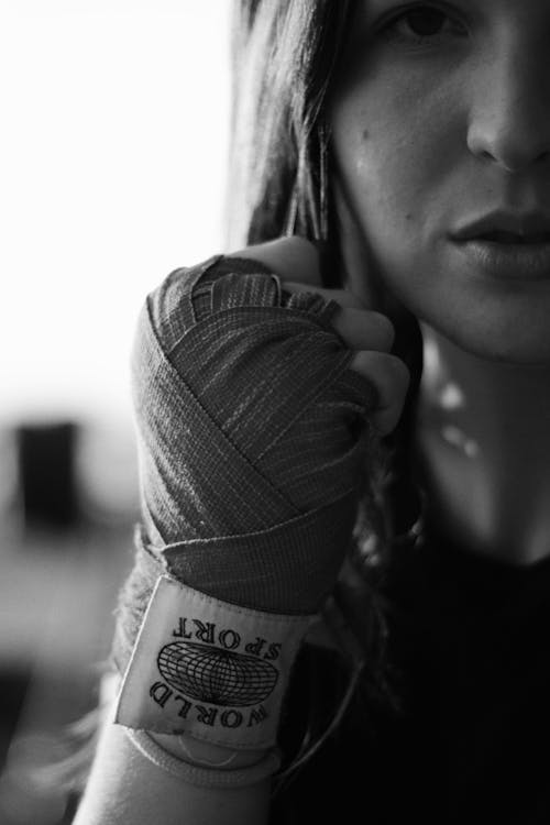 Grayscale Photo of Woman Wearing a Hand Wrap