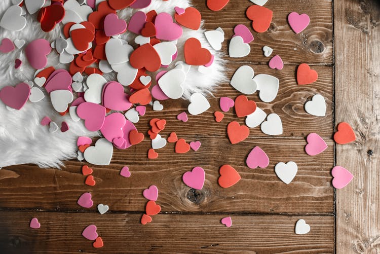 Heart Shaped Confetti On Wooden Floor