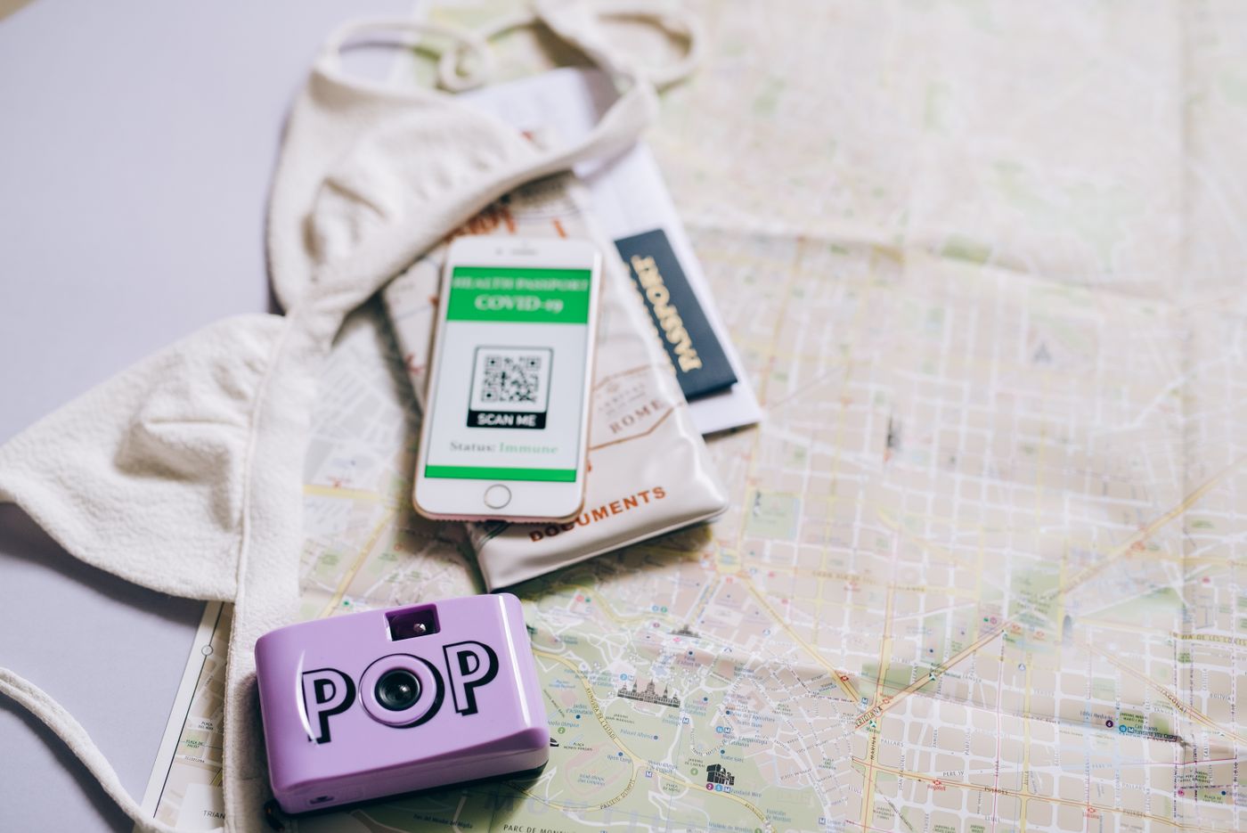 Passport, map and travel essentials for visa journey