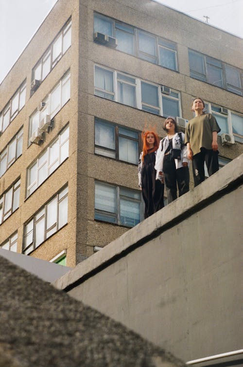 Group of Friends Standing on Roof of Building