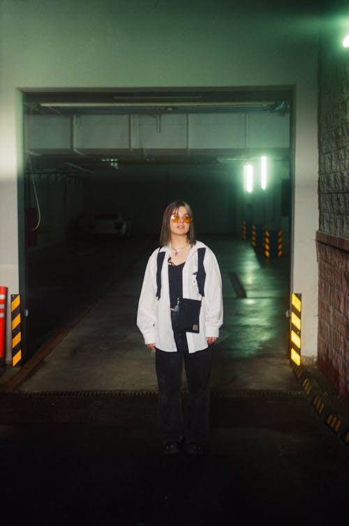 Woman Standing in Entrance to Underground Parking Lot