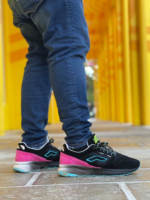 Free Person Wearing Blue Jeans and Sneakers Stock Photo