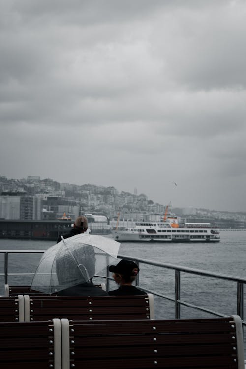 Passengers on the Open Deck of a Ferry Sailing Across the Bosphorus Strait on a Cloudy Day