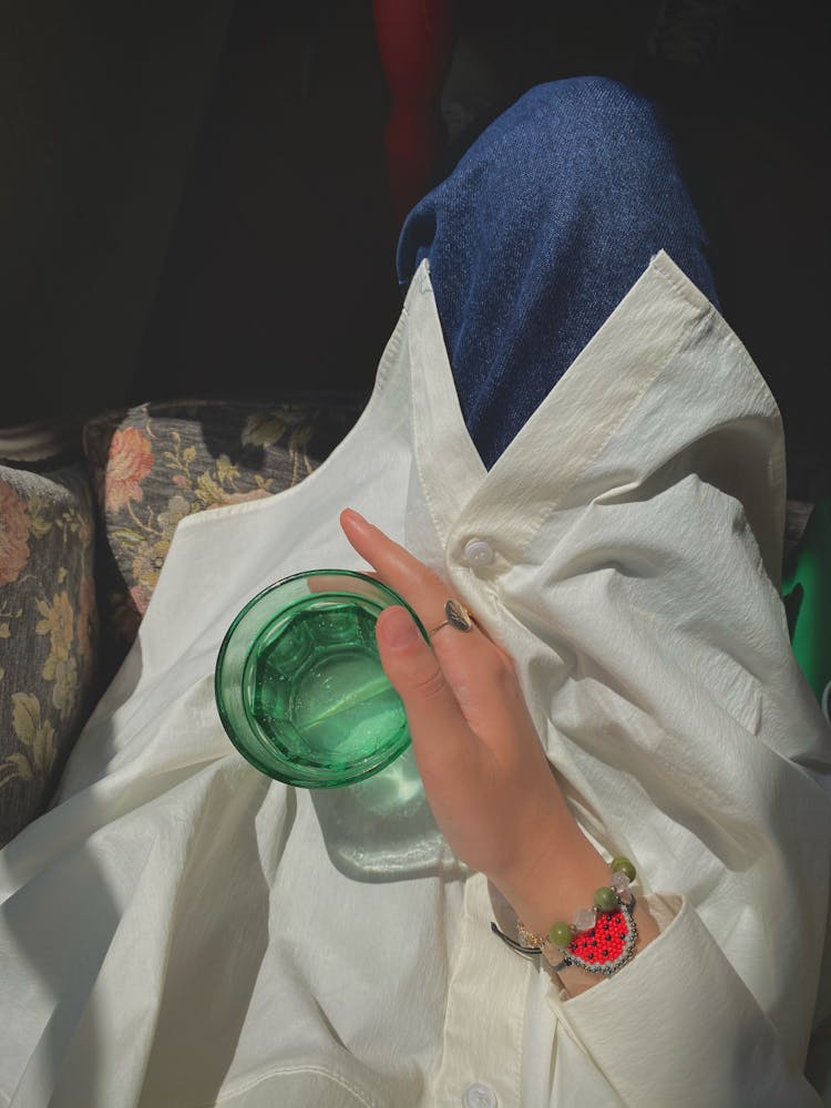 Woman Holding Glass Of Water On Her Lap