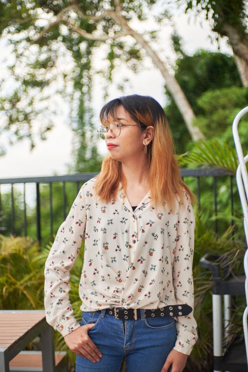 Free Portrait of a fashionable Asian woman with dyed hair, wearing glasses, taken outdoors. Stock Photo