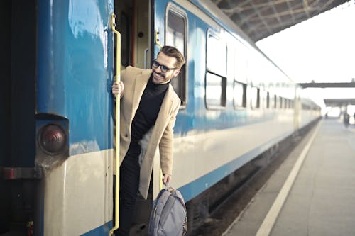 Free Man Wearing Beige Overcoat Inside Train Stock Photo