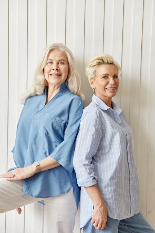 Smiling Blonde Women Posing by Wall