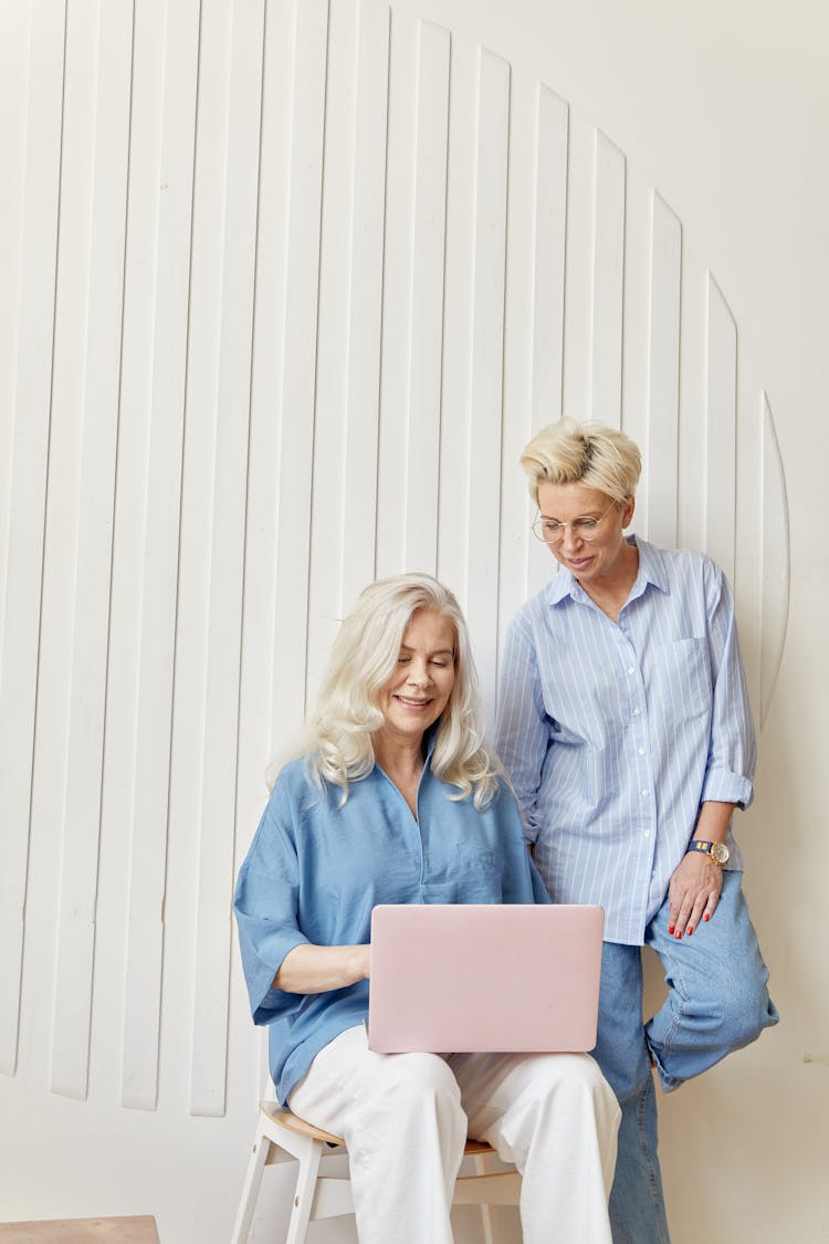 Women Looking At The Screen Of A Laptop