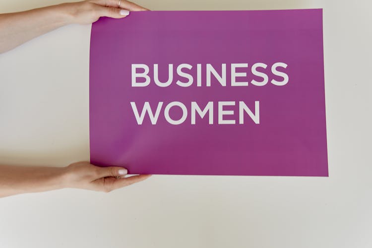 Hands Holding Business Women Sign